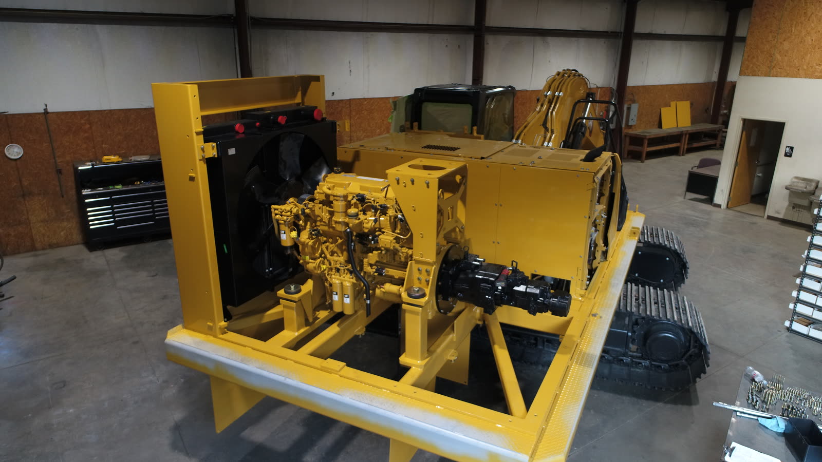 CAT engine and hydraulic pump mounted on a power pack skid during assembly, aerial view