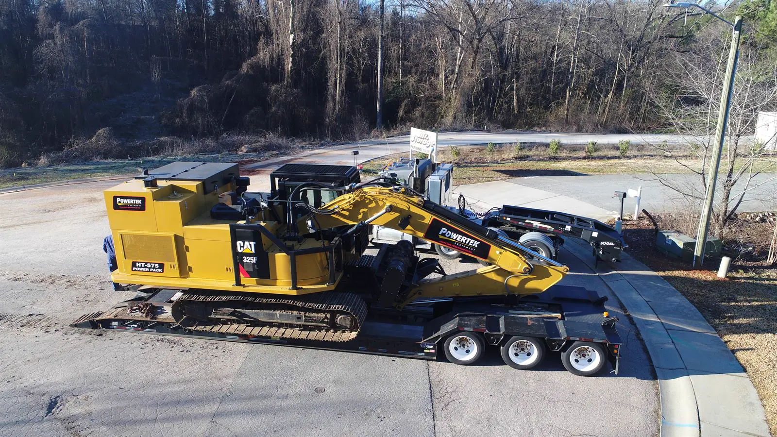 HT-575 Power Pack on CAT 325F loaded on a lowboy trailer for delivery