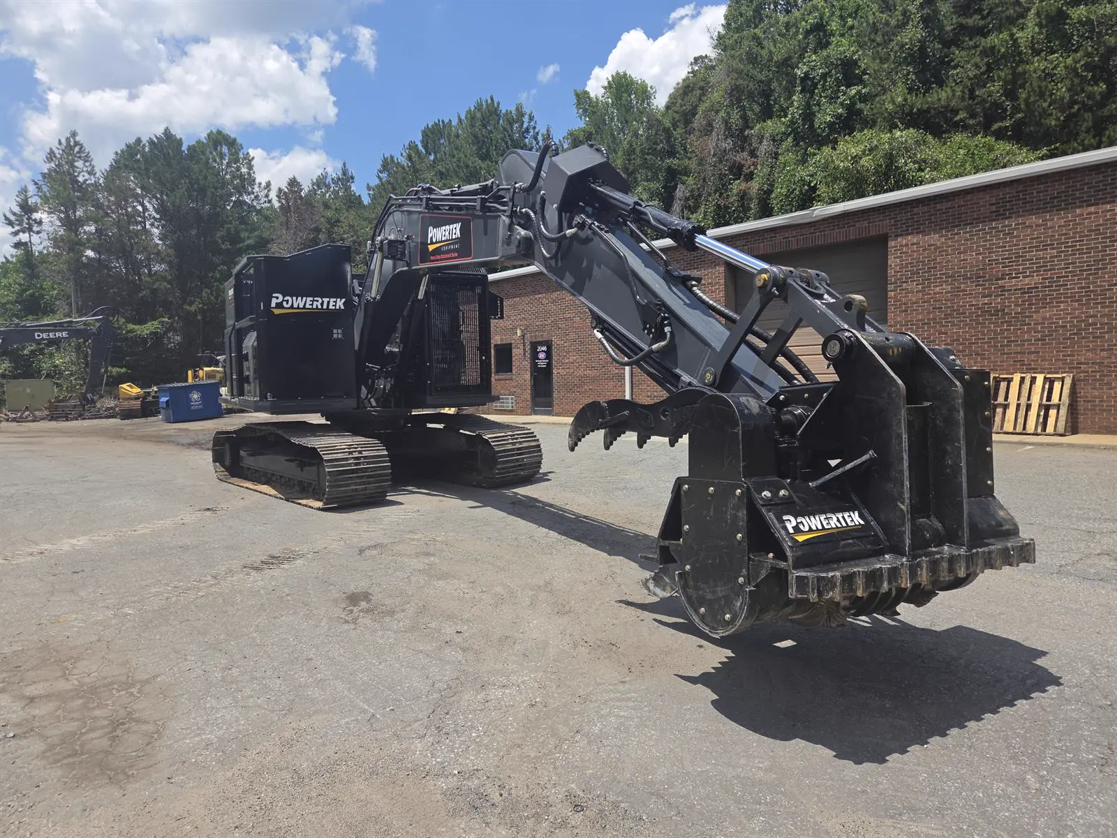 Powertek XPE-200-575 excavator with forestry guarding and cutterhead, front three-quarter view